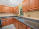 Kitchen features light-colored cabinets, stone countertops, and a stainless steel faucet at 3205 N 66Th St, Tampa, FL 33619