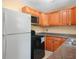 Kitchen features light-colored cabinets, stone countertops, and black appliances at 3205 N 66Th St, Tampa, FL 33619
