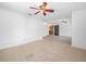 Bright living room with neutral tile flooring and a ceiling fan for comfort at 3205 N 66Th St, Tampa, FL 33619