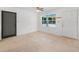 Bright living room features tile floors, windows offering natural light, and two doors at 3205 N 66Th St, Tampa, FL 33619