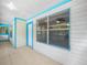 Screened porch features tile flooring and a view inside through a large window at 3205 N 66Th St, Tampa, FL 33619