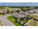 Aerial view of a one-story home with a screened lanai, situated in a residential neighborhood with green spaces at 3419 Trapnell Ridge Dr, Plant City, FL 33567