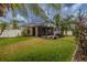 Expansive backyard featuring lush green grass, a privacy fence, and a screened-in lanai at 3419 Trapnell Ridge Dr, Plant City, FL 33567