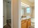Bathroom with granite countertop, tile backsplash, and wood cabinets at 3419 Trapnell Ridge Dr, Plant City, FL 33567