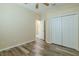 Clean bedroom featuring wood-look floors, a ceiling fan, closet, and neutral paint at 3419 Trapnell Ridge Dr, Plant City, FL 33567