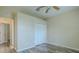 Bedroom featuring wood-look floors, closet with bi-fold doors and neutral paint at 3419 Trapnell Ridge Dr, Plant City, FL 33567