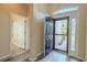 Bright foyer with wood-look flooring and a view of the front door and adjacent bathroom at 3419 Trapnell Ridge Dr, Plant City, FL 33567