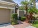 Home exterior with neatly manicured landscaping, walkway to front door, and an attached garage at 3419 Trapnell Ridge Dr, Plant City, FL 33567