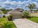 Well-maintained one-story home with vibrant lawn, manicured landscaping, and a private driveway leading to a two-car garage at 3419 Trapnell Ridge Dr, Plant City, FL 33567