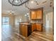 Kitchen area open to living space with stainless appliances, a breakfast bar, and wood flooring at 3419 Trapnell Ridge Dr, Plant City, FL 33567