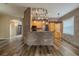Modern kitchen featuring brick accent walls, wooden cabinets, granite countertops, and stainless steel appliances at 3419 Trapnell Ridge Dr, Plant City, FL 33567