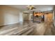 Open-concept living room featuring modern wood-look flooring, and a breakfast bar with wooden cabinets at 3419 Trapnell Ridge Dr, Plant City, FL 33567