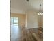 Living room with an elegant chandelier, wood flooring, and sliding glass door leading to outdoor space at 3419 Trapnell Ridge Dr, Plant City, FL 33567