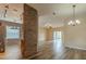 Open-concept living room with wood-look flooring, brick accent wall, and sliding doors to the backyard at 3419 Trapnell Ridge Dr, Plant City, FL 33567
