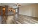Spacious living room featuring wood flooring and a breakfast bar with wood cabinets at 3419 Trapnell Ridge Dr, Plant City, FL 33567