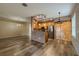 Bright open space with living area and kitchen featuring wood floors, stainless steel appliances, and brick accents at 3419 Trapnell Ridge Dr, Plant City, FL 33567
