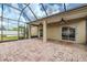 Screened-in brick patio with ceiling fans, offering a relaxing outdoor living space at 3419 Trapnell Ridge Dr, Plant City, FL 33567