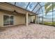 Large screened-in patio with brick floors and an outdoor fan at 3419 Trapnell Ridge Dr, Plant City, FL 33567