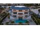 Stunning aerial view of a two-story house with a beautiful pool and lush landscaping at 531 68Th St, Holmes Beach, FL 34217