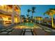 Serene backyard featuring a shimmering pool, lush palms, waterfront views, and elegant outdoor seating at 531 68Th St, Holmes Beach, FL 34217