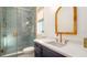 Stylish bathroom features a shower with glass doors, updated fixtures, and marble countertops at 531 68Th St, Holmes Beach, FL 34217