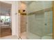 Modern bathroom with a glass shower, gold hardware, and view into the bedroom and balcony at 531 68Th St, Holmes Beach, FL 34217