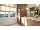 Bright bathroom with a marble countertop vanity, updated fixtures, storage, and natural light at 531 68Th St, Holmes Beach, FL 34217