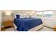 Cozy bedroom featuring a comfortable bed, stylish lamps, and a large window for natural light at 531 68Th St, Holmes Beach, FL 34217
