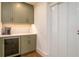 Butler pantry features green cabinetry, herringbone backsplash, and beverage refrigerator at 531 68Th St, Holmes Beach, FL 34217
