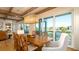 Dining room features a large dining table and view through a wall of windows at 531 68Th St, Holmes Beach, FL 34217