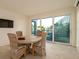 Bright dining area with deck access features stylish seating and beachy decor at 531 68Th St, Holmes Beach, FL 34217