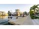 Modern dock with boat lift and water access, surrounded by tropical landscaping at 531 68Th St, Holmes Beach, FL 34217