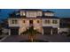 Elegant exterior of a two-story home featuring a charming front porch and a three-car garage at 531 68Th St, Holmes Beach, FL 34217