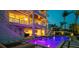 Multi-story home exterior showcases a pristine pool, manicured landscaping, and elegant waterfront setting at 531 68Th St, Holmes Beach, FL 34217