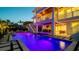 Elegant waterfront home with a stunning pool, lush landscaping, and inviting outdoor entertainment areas at 531 68Th St, Holmes Beach, FL 34217