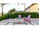 Cozy outdoor fire pit with stylish Adirondack chairs, complemented by meticulous landscaping and a serene ambiance at 531 68Th St, Holmes Beach, FL 34217