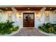 Elegant double front doors with sidelights flanked by tropical landscaping at 531 68Th St, Holmes Beach, FL 34217