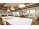 Bright kitchen features a large center island, wood beams, and a view to the dining area at 531 68Th St, Holmes Beach, FL 34217