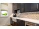 Beautiful kitchen features dark cabinets, stainless appliances, and a farmhouse sink at 531 68Th St, Holmes Beach, FL 34217