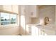 Bright laundry room features a sleek sink, marble countertops, updated fixtures, and storage at 531 68Th St, Holmes Beach, FL 34217