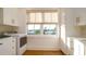 Functional laundry room with modern appliances, ample cabinet space, and a view to the outdoors at 531 68Th St, Holmes Beach, FL 34217