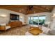 Cozy living room boasts wood ceiling, deck access, and stylish furnishings at 531 68Th St, Holmes Beach, FL 34217