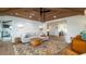 Bright living room features a statement rug, wood ceiling, and seamless flow at 531 68Th St, Holmes Beach, FL 34217