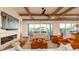 Spacious living room features beamed ceiling, a fireplace, comfortable seating and water views at 531 68Th St, Holmes Beach, FL 34217