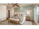 Bright main bedroom featuring paneled walls, a ceiling fan, and access to a balcony at 531 68Th St, Holmes Beach, FL 34217
