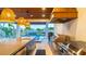 An outside kitchen with stainless steel appliances, concrete countertops, and a view of the outdoor pool at 531 68Th St, Holmes Beach, FL 34217