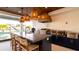 Covered outdoor kitchen with bar seating, sink, grill and wood ceiling at 531 68Th St, Holmes Beach, FL 34217