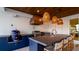 Outdoor kitchen featuring built-in grill, sink and dark blue cabinets at 531 68Th St, Holmes Beach, FL 34217