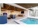 Spacious covered patio with outdoor kitchen, dining area, and swimming pool at 531 68Th St, Holmes Beach, FL 34217