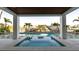 Captivating view from the covered patio, showcasing the inviting pool, spa, and waterfront scenery with boats at 531 68Th St, Holmes Beach, FL 34217